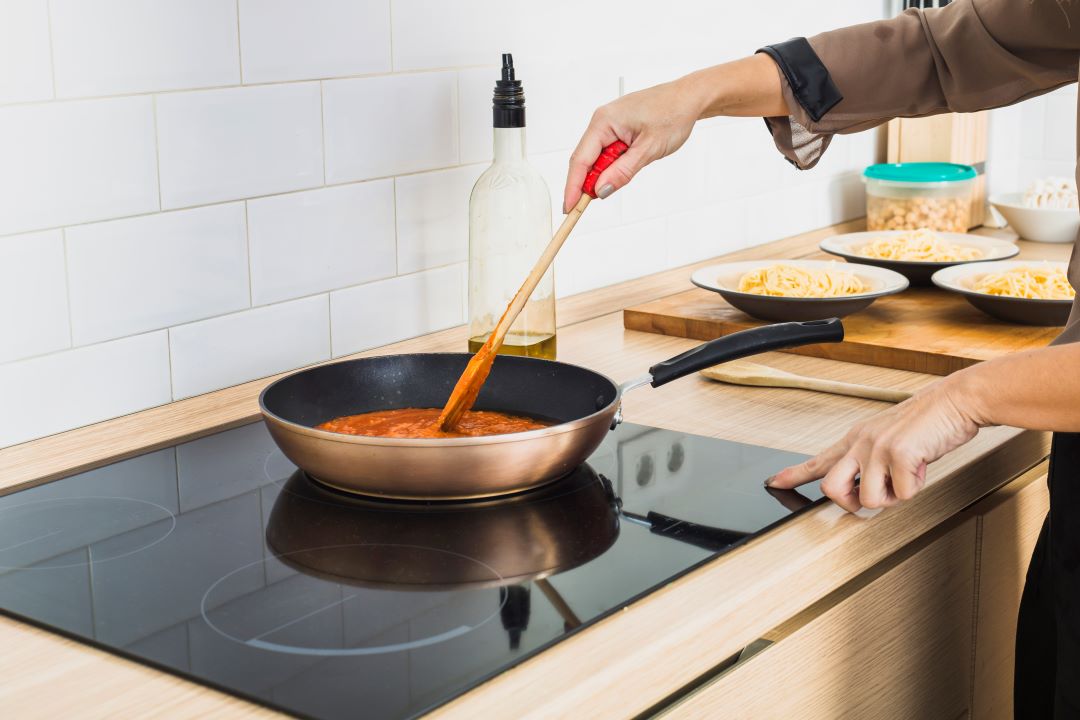 Person Mixing Sauce Pan Stove